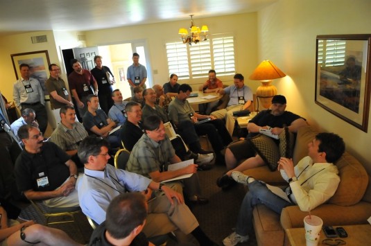 Wall Street analyst Jay Vleeschhouwer (lower right, on couch) presents a briefing at COFES. Each year the conference mixes small groups presentations and discussions with larger meetings. The setting and the schedule are designed to encourage ad-hoc one-on-one meetings. (Source: Deelip Menezes) 