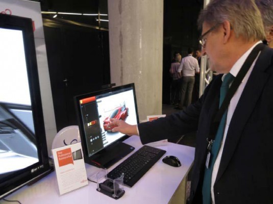 Wilhelm Geyer, the director of Fujitsu’s workstations, demonstrates Fujitsu’s remote computing product at RTT Excite 2013. In the demo, Geyer interactively changes the color of the car. There was a lot of that at RTT’s event. (Source: JPR)