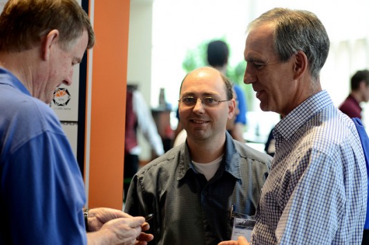 Bill McClure, left, VP of product development for Solid Edge, chats with attendees at the opening session of Solid Edge University 2013 this week in Cincinnati. 